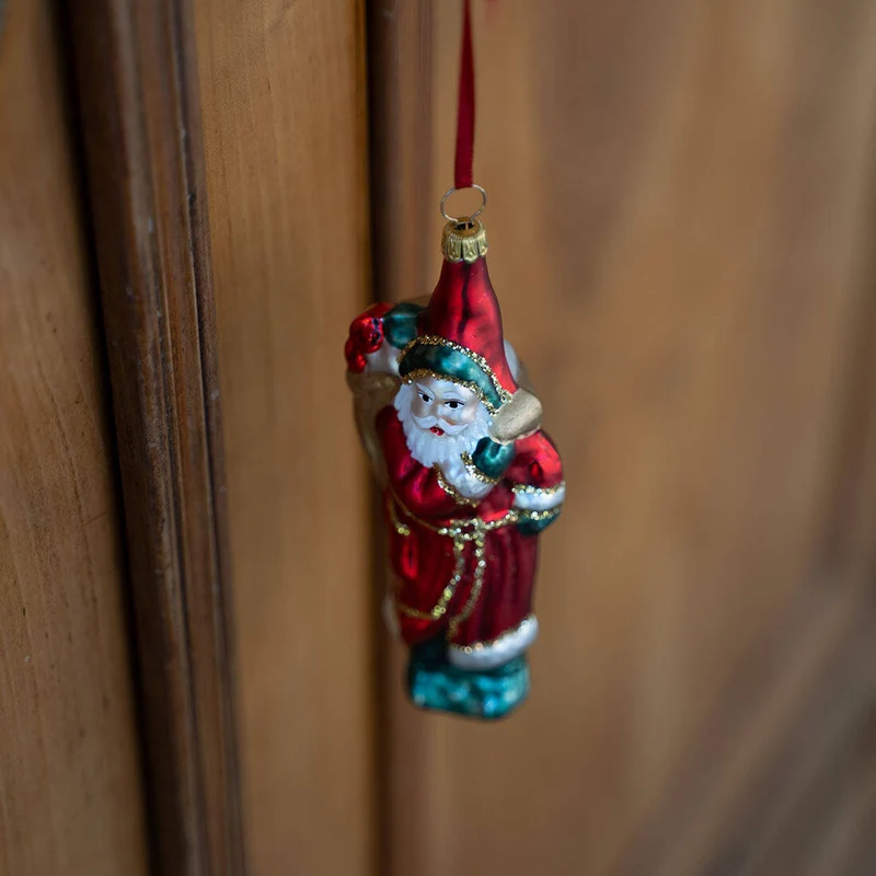 Weihnachtsmannfigur mit Rucksack aus Glas